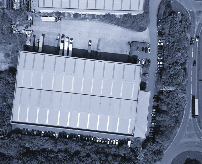Bird’s eye view of a modern logistics warehouse in blue duotone
